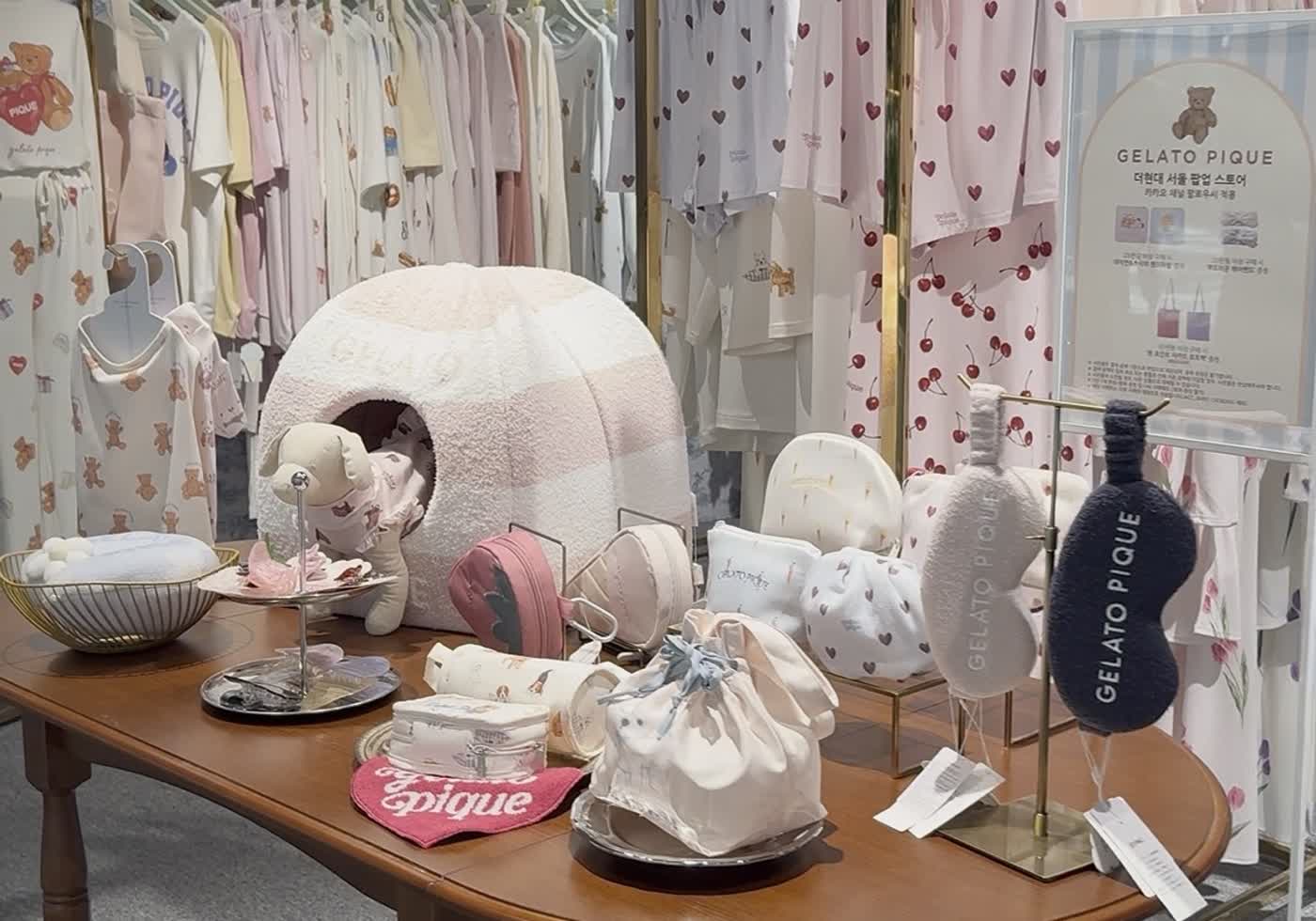 Cute Korean fashion boutique with racks of clothes and a display table