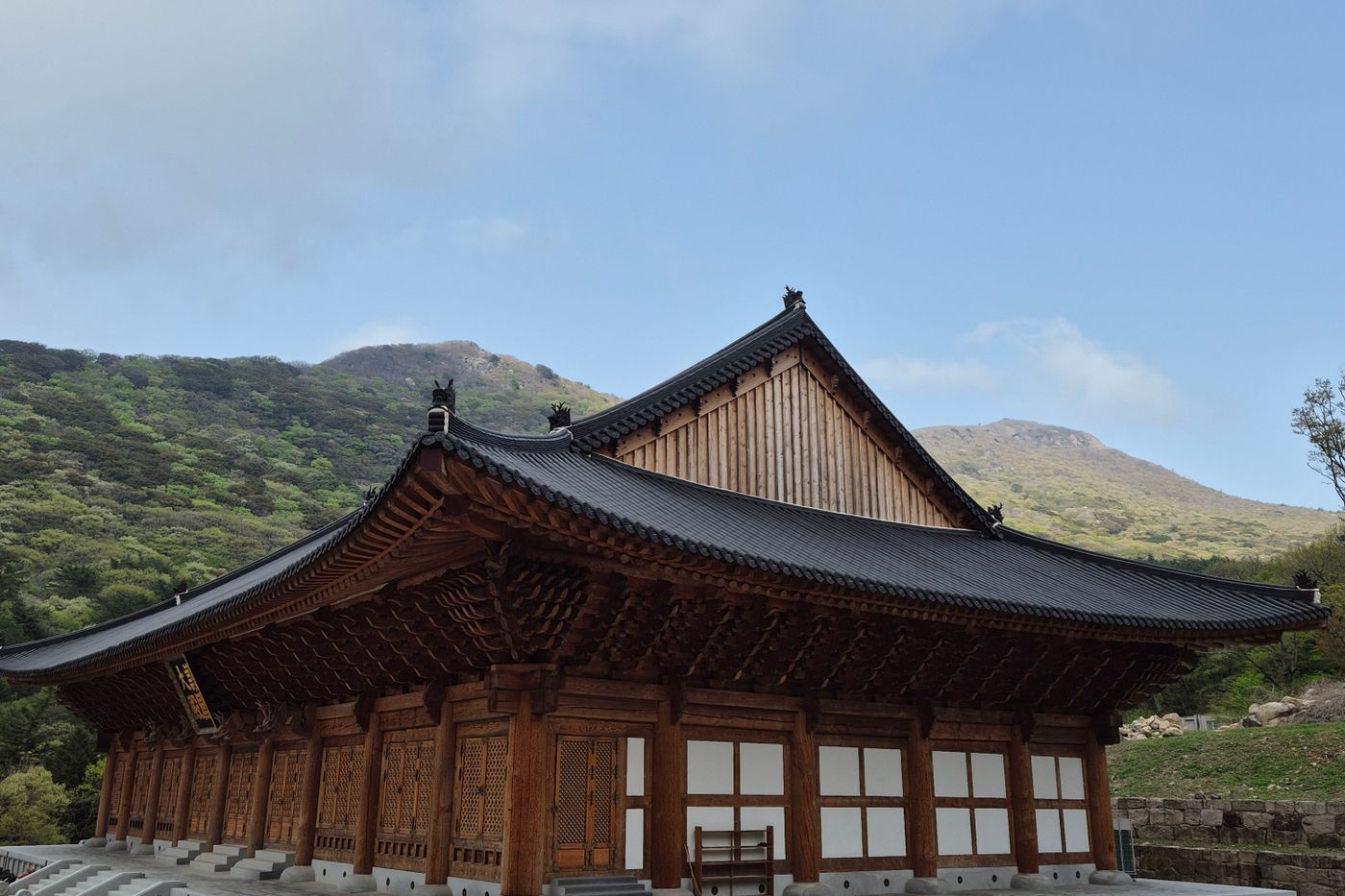 Traditional Korean temple in a lush mountain landscape